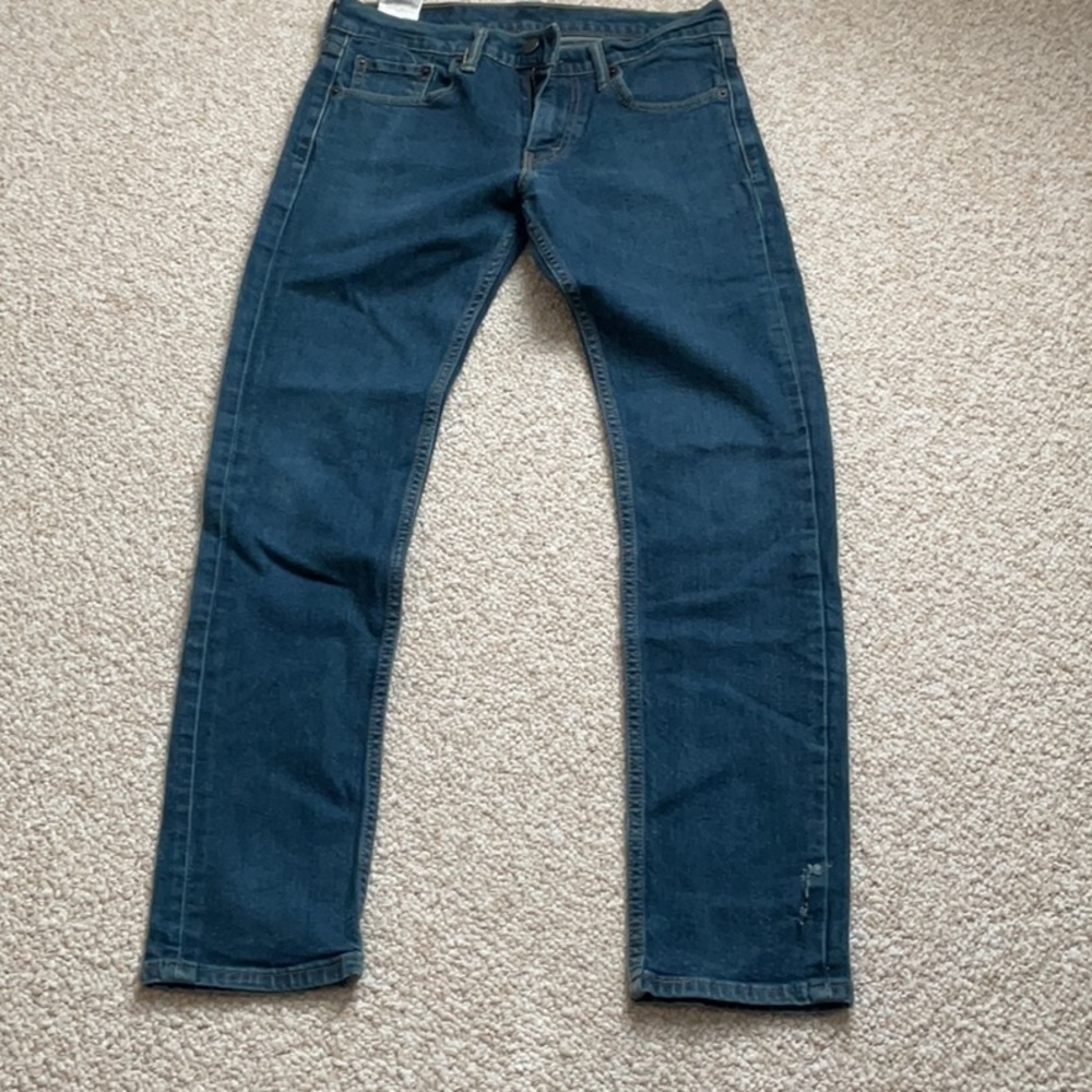 LEVI’S 511 blue jeans. Small tear for that distressed look.
